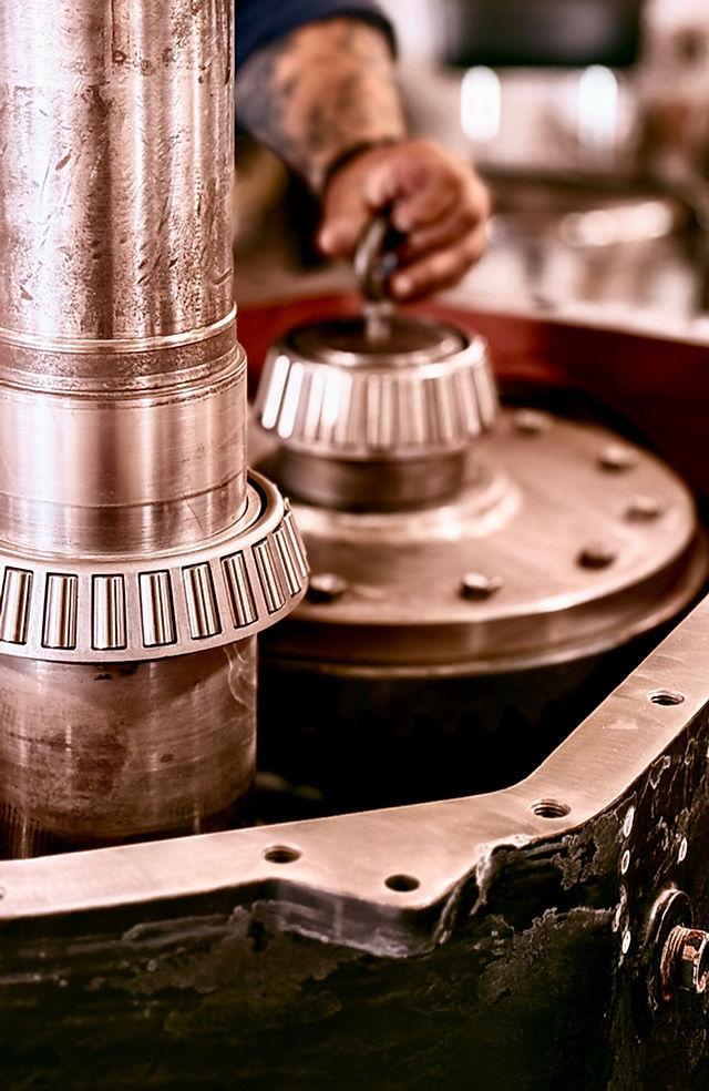 Tapered roller bearing cone and separate outer cup on a clean industrial surface Tapered roller bearing cone and separate outer cup on a clean industrial surface